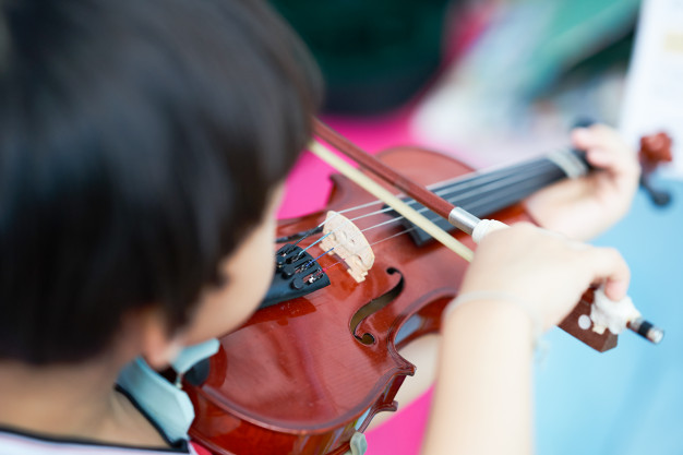 rear view action boy plays violin blur note background selective focus 68799 390